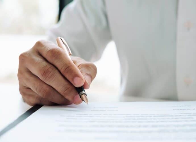 signing a contract to illustrate page on sales policies